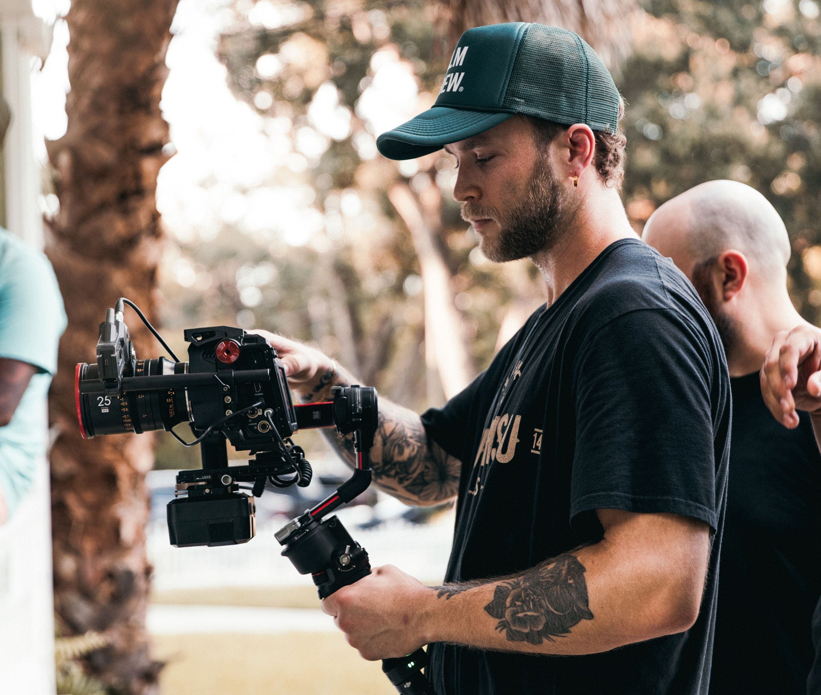 Camera operator adjusting gear during a video shoot