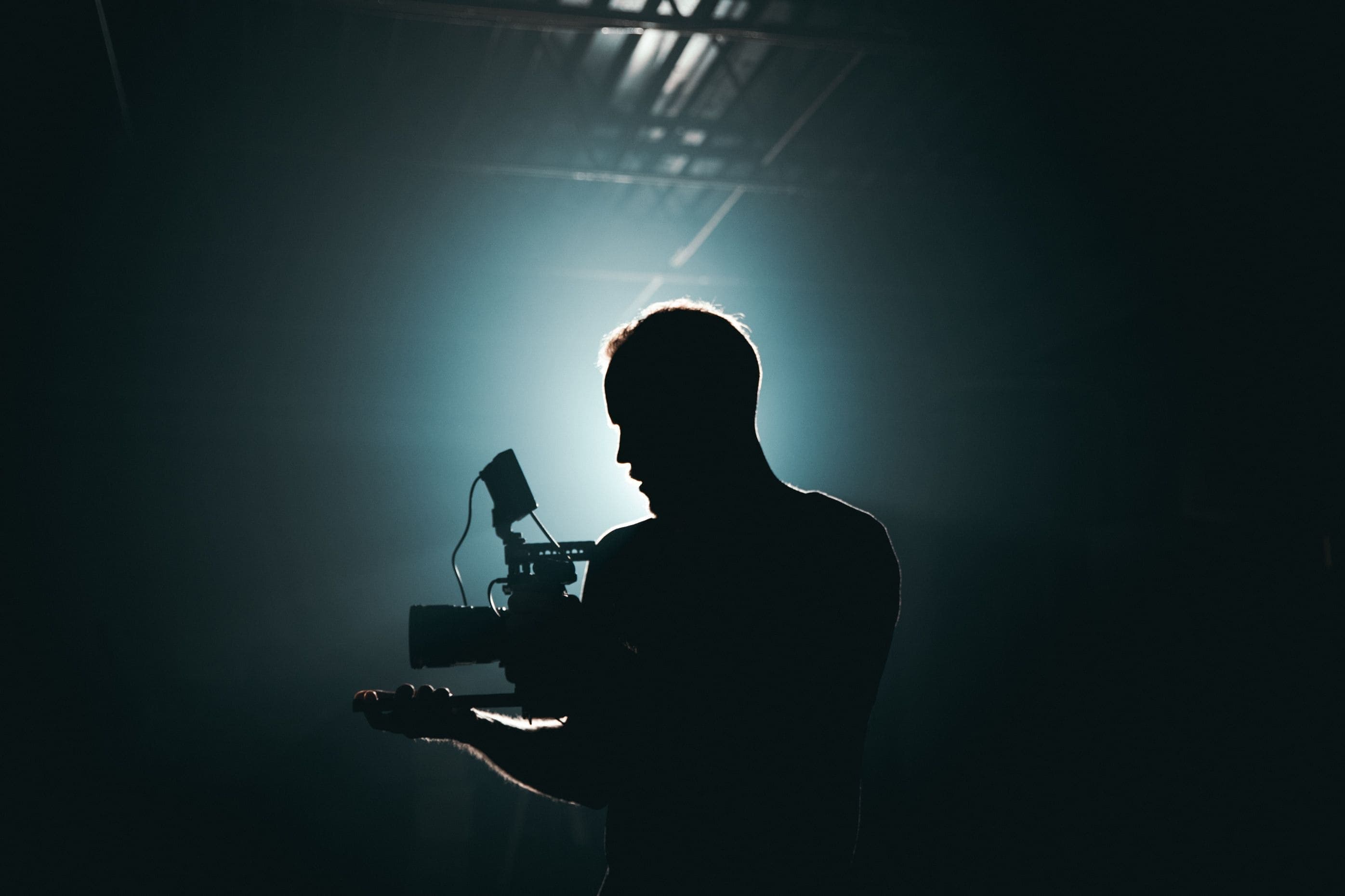 Videographer filming on location with a cinema camera