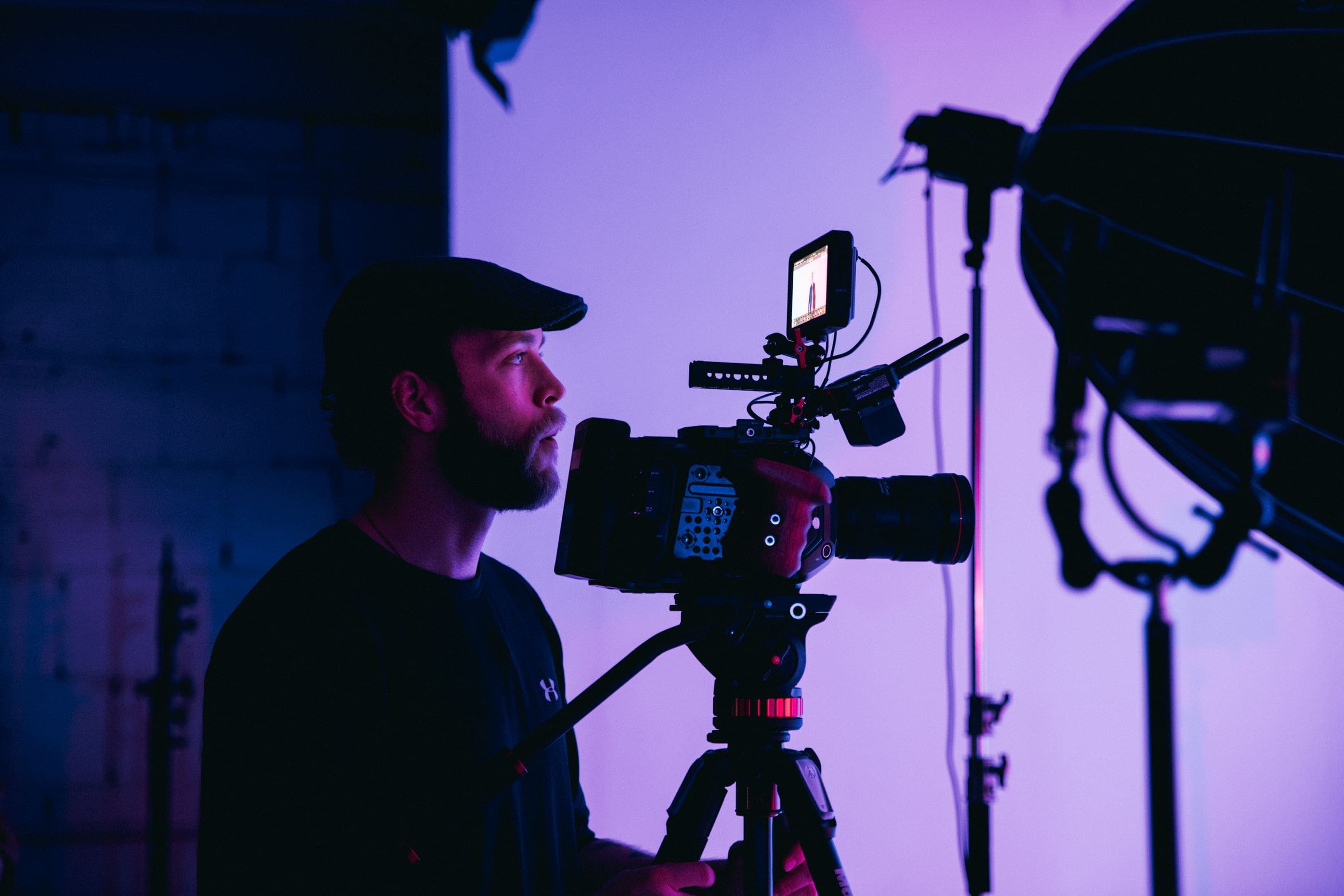Videographer reviewing a signed video production contract on a laptop